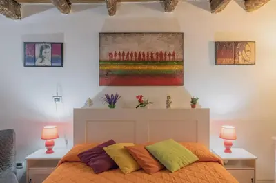 a bedroom with a bed and a painting on the wall at La casetta di Sara in Palermo
