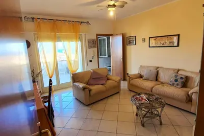 a living room with two couches and a table at Spacious apartment with sea view in Alcamo, 180 m² in Alcamo