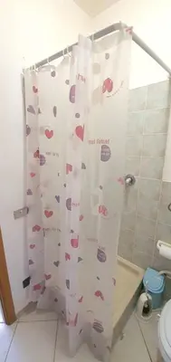 a bathroom with a shower curtain with hearts on it at Spacious apartment with sea view in Alcamo, 180 m² in Alcamo