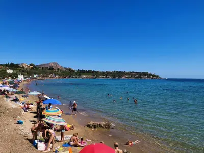 a beach with a bunch of people in the water at Villa Nico in Casteldaccia
