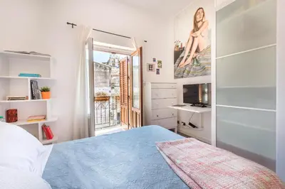 a bedroom with a blue bed and a window at Terrazza dei Colori alla Kalsa by Wonderful Italy in Palermo
