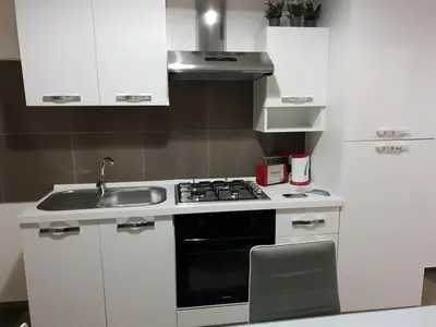 a small kitchen with a stove and a sink at CASE VACANZE NONNA NICK in Castellammare del Golfo