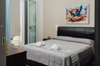 a bedroom with a bed with towels on it at Giardini del Golfo Villa al Mare in Balestrate