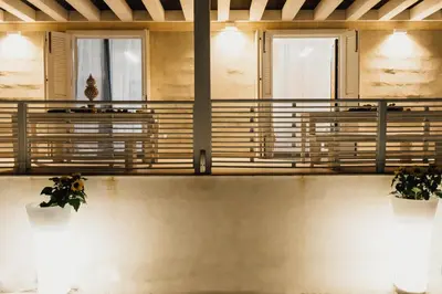 a balcony in a building with two potted plants at Giardini del Golfo Villa al Mare in Balestrate