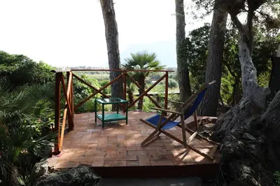 a deck with a chair and a table at Casa Elvira in Terrasini