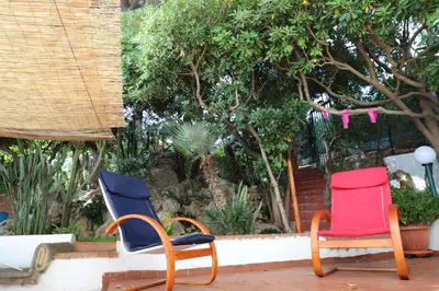 a couple of chairs sitting on a patio at Casa Elvira in Terrasini