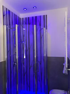 a bathroom with a glass shower with a toilet at LA FINESTRA SUL PORTO in Palermo