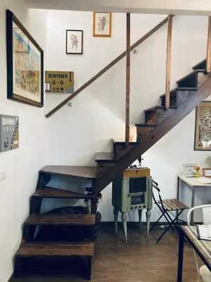 a room with a wooden staircase with a desk and a desk at Addimora Boutique Suites in Palermo