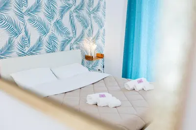 a bedroom with a bed with towels on it at Zangara Flat in Cinisi
