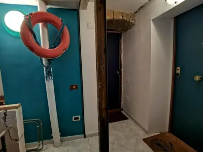 a room with a red life preserver hanging on the wall at CasuzzaMia in Palermo