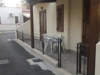 a balcony of a house with a fence at Acqua Chiara Appartamenti in San Vito lo Capo