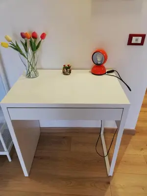 a white table with a vase of flowers on it at Casa Annuccia ai Quattro Canti di Città in Palermo