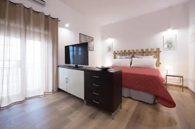 a bedroom with a bed with a television on a dresser at Casa Annuccia ai Quattro Canti di Città in Palermo