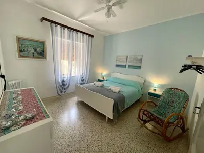 a bedroom with a bed and a chair at Sea Front in Carini