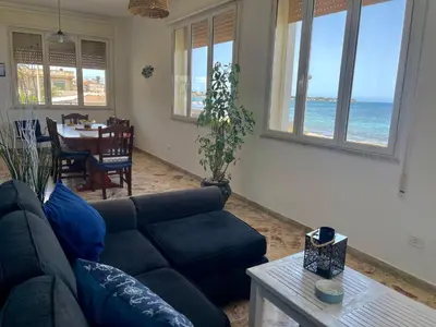 a living room with a couch and a table at Sea Front in Carini