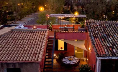 an overhead view of a building with a table on a balcony at Palermo Magic House in Palermo
