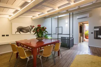 a dining room with a wooden table and chairs at Palermo Magic House in Palermo