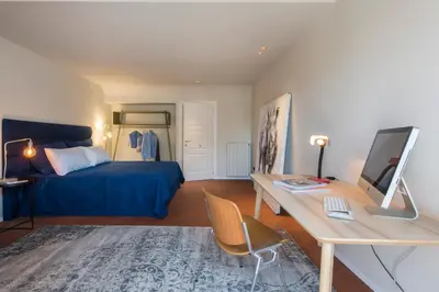 a bedroom with a bed and a desk with a computer at Palermo Magic House in Palermo