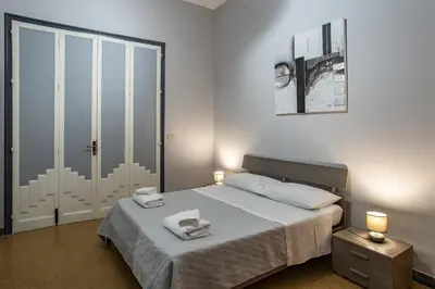 a bedroom with a bed with two towels on it at GiaChi friendly rooms alla Stazione in Palermo