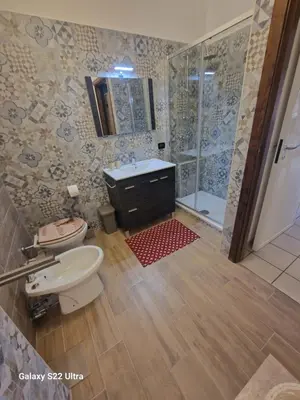 a bathroom with a toilet and a sink and a shower at Casa Sabrina in San Vito lo Capo