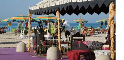 a group of people on a beach with umbrellas at Casa Sabrina in San Vito lo Capo