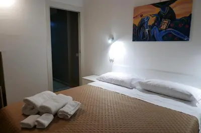 a bedroom with two towels on a bed at Opera Boutique Rooms in Monreale