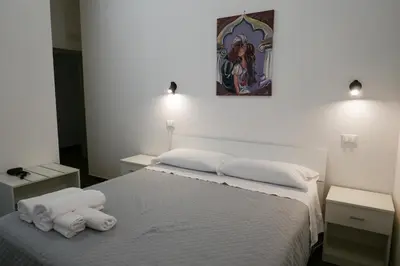 a bedroom with two white towels on a bed at Opera Boutique Rooms in Monreale