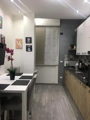a kitchen with a table with chairs and a counter top at Casa Le Rose in Palermo