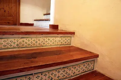 a room with a wooden staircase with tiles on the wall at Casa Vacanza nell'Orto in Termini Imerese