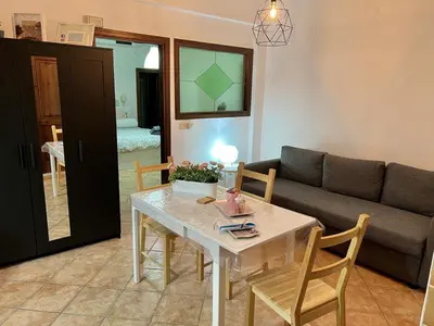 a living room with a table and a couch at Lisetta's house in Monreale