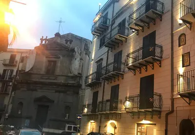 a group of buildings with balconies on a street at La Serenissima Hotel in Palermo