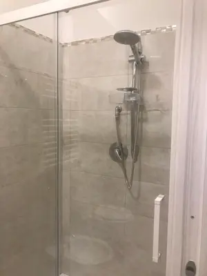 a shower in a bathroom with a glass door at La Serenissima Hotel in Palermo