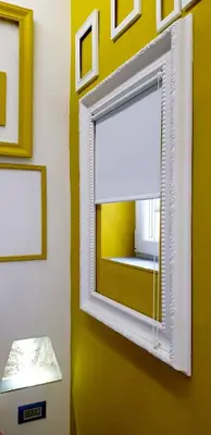 a mirror on a wall with pictures on it at Mediterraneo House in Palermo