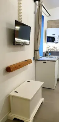 a kitchen with a counter and a tv on the wall at Mediterraneo House in Palermo