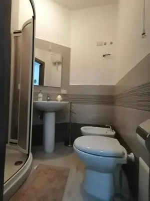 a bathroom with a toilet and a sink at La Trinacria in Terrasini