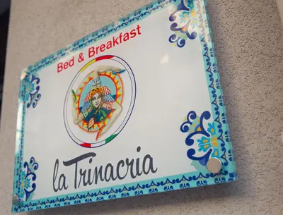 a cake with a sign that reads bed and breakfast la timuna at La Trinacria in Terrasini