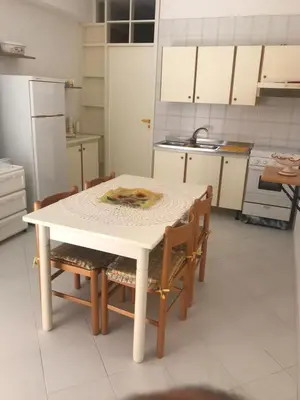 a kitchen with a white table and chairs in it at Casa Vacanze Ciullo d'Alcamo in San Vito lo Capo