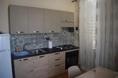 a kitchen with a sink and a counter top at Affitto breve Casa Taormina in Palermo