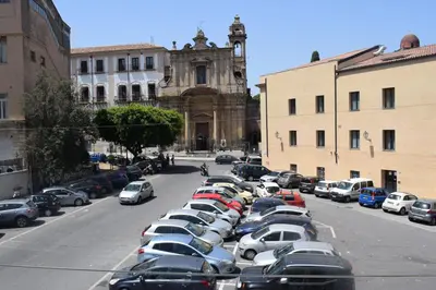 a row of cars parked in a parking lot at Affitto breve Casa Taormina in Palermo
