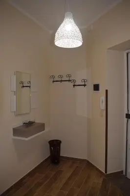 a room with a mirror and a light on the wall at Affitto breve Casa Taormina in Palermo