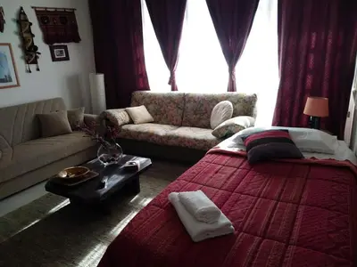a living room with a large bed and a couch at Gibellina Home in Nuova Gibellina