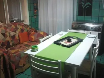 a living room with a table and a couch at Gibellina Home in Nuova Gibellina