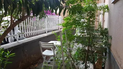 a white chair sitting on a balcony with a fence at Clambè in Palermo