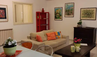 a living room with a couch and a table at Appartamento a due passi dal mare in Palermo
