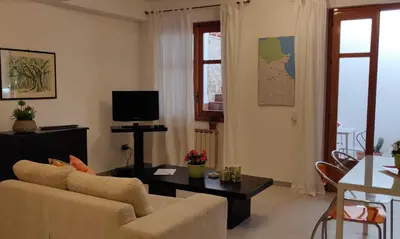 a living room with a couch and a table at Appartamento a due passi dal mare in Palermo