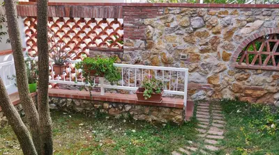 a stone wall with a bench with potted plants on it at Appartamento a due passi dal mare in Palermo