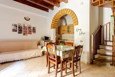a kitchen and living room with a table and chairs at Nino's house in Palermo