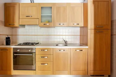 a kitchen with wooden cabinets and a sink at Nino's house in Palermo