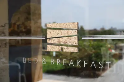 a window with the words bed and breakfast on it at b&b Pirriera in Bagheria