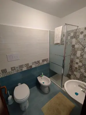 a bathroom with a toilet and a sink at Sicilia Bedda isolotto in Isola delle Femmine